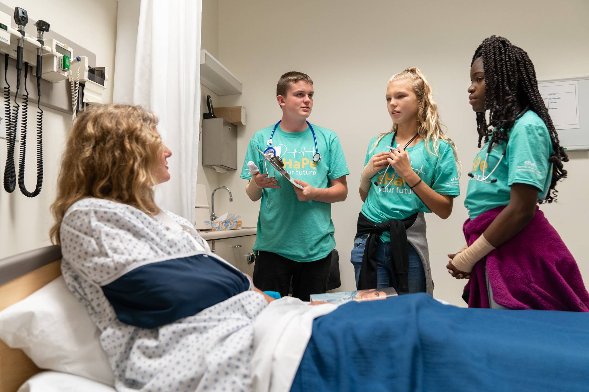Students in simulation center with patient